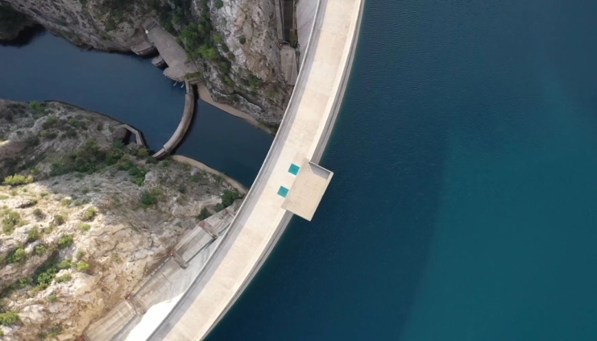 aerial shot of a dam and bridge