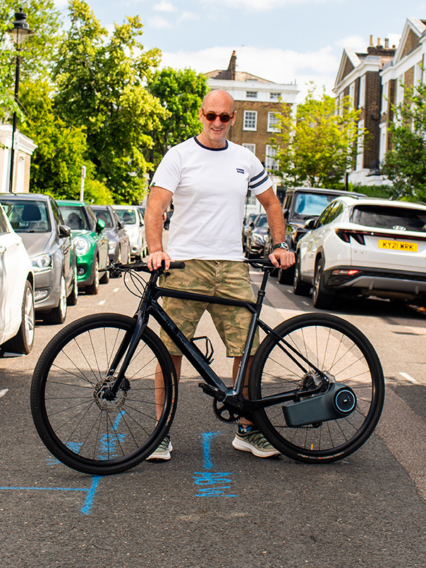 Image of Ean Brown with a bike standing in a road